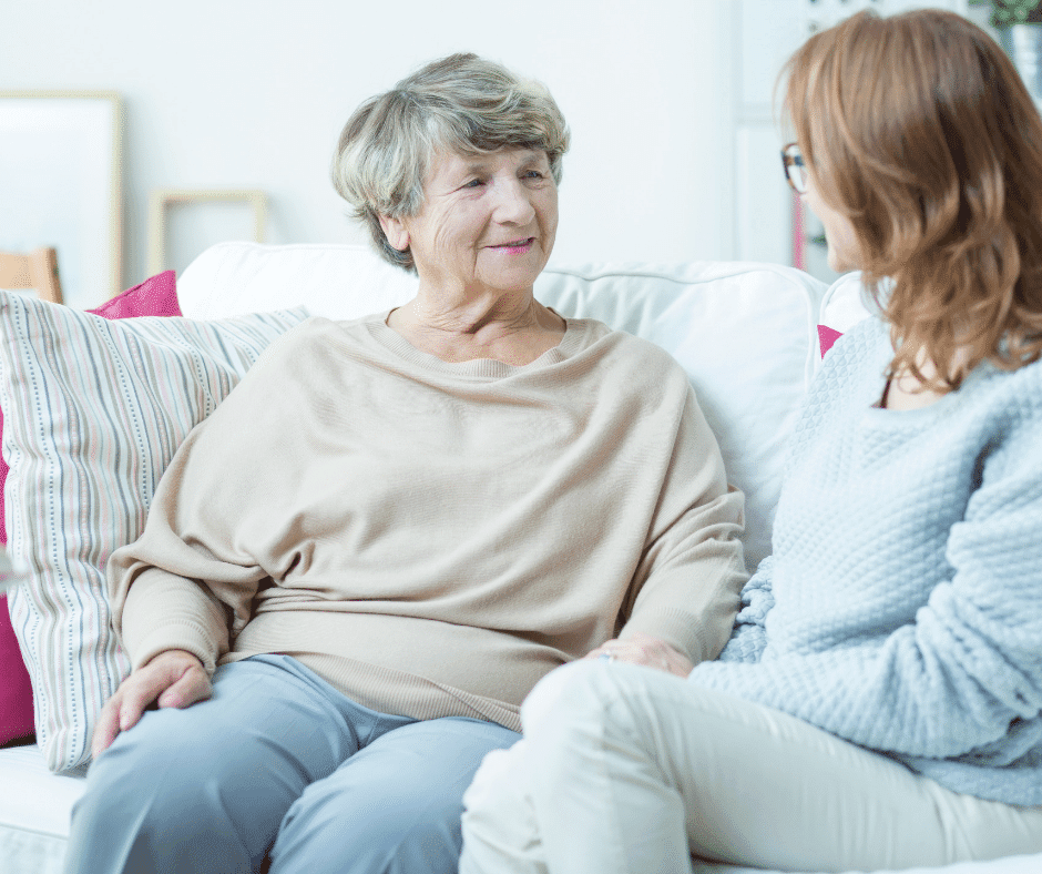 mother and daughter talking on couch